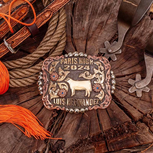 A custom graduation belt buckle for Paris High with personalized name featuring a golden bronze cow figure 